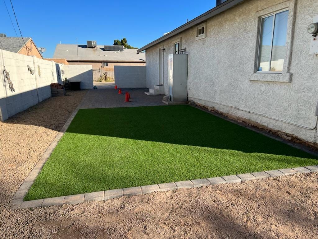 A house with a large lawn in front of it.