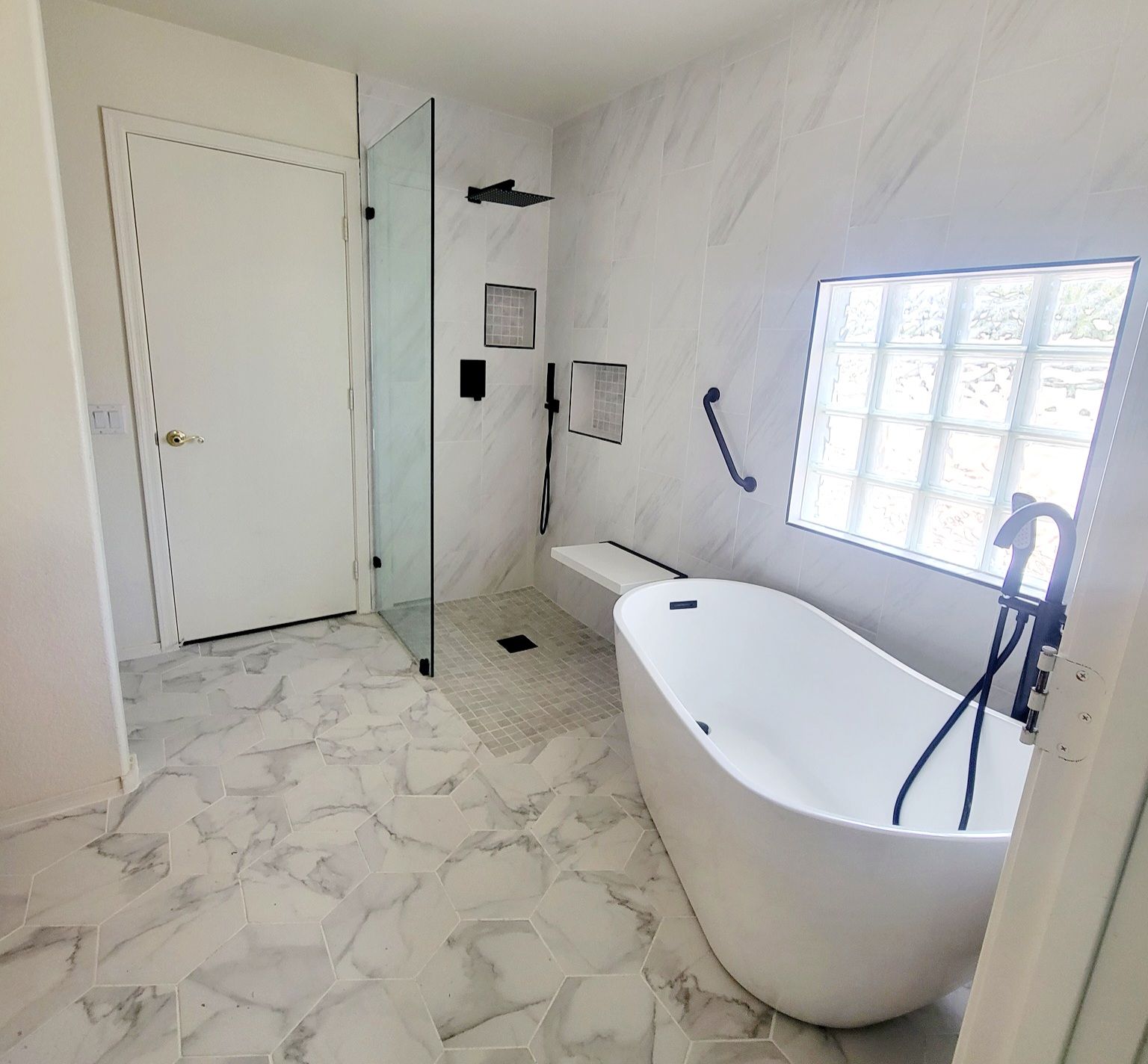 A bathroom with a bathtub and a walk in shower