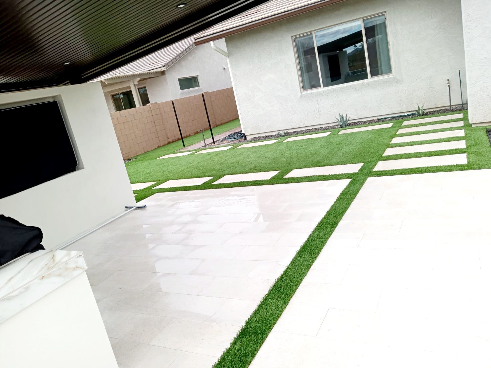 A white house with a green lawn in front of it.