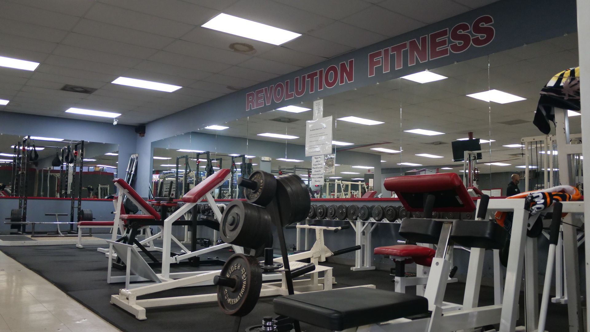 A gym with a sign that says revolution fitness