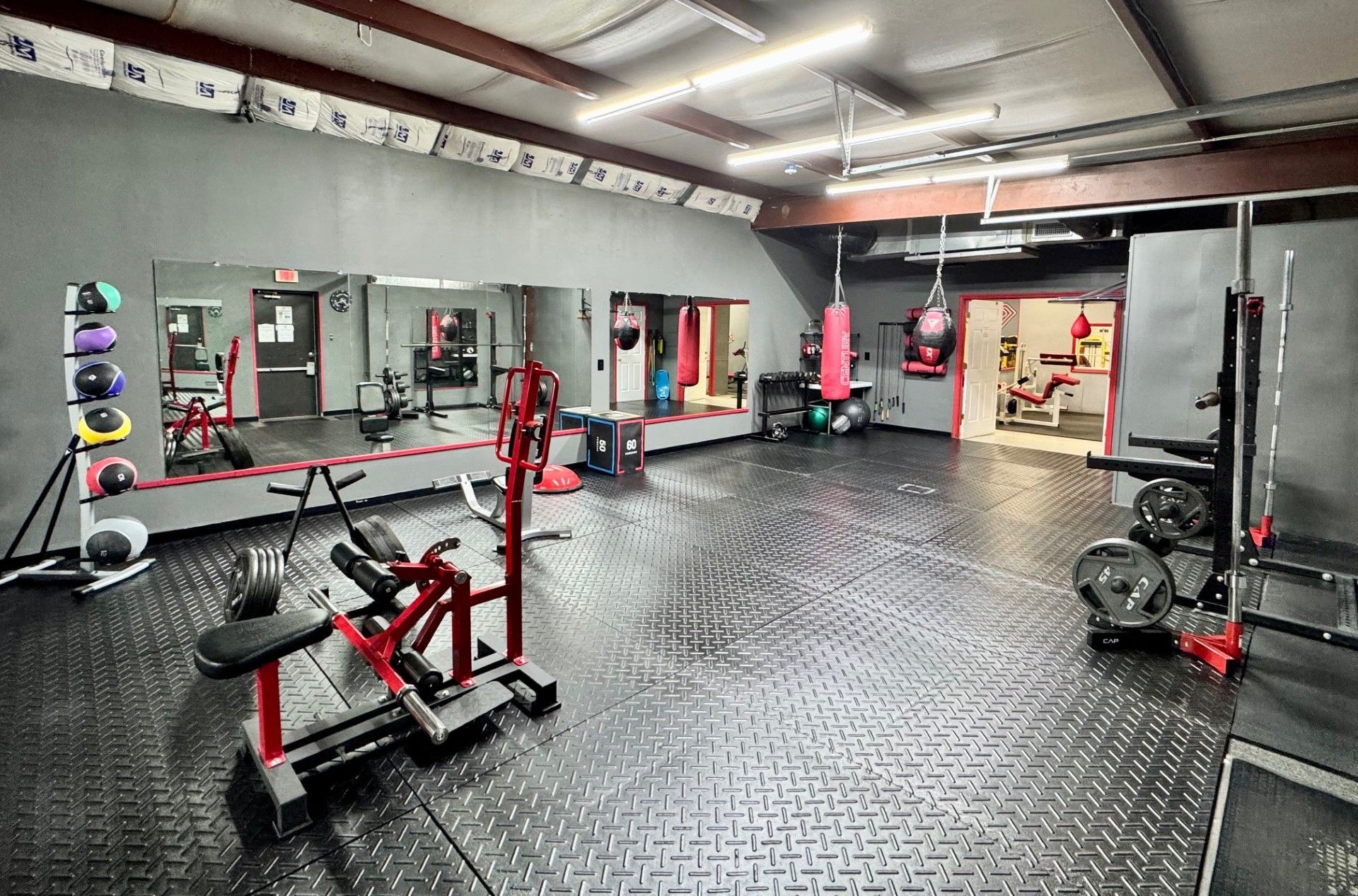 A woman is riding an exercise bike in a revolution fitness center