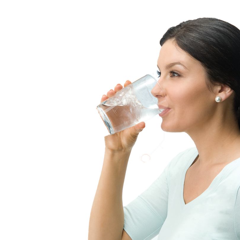 Woman drinking from a glass of water.
