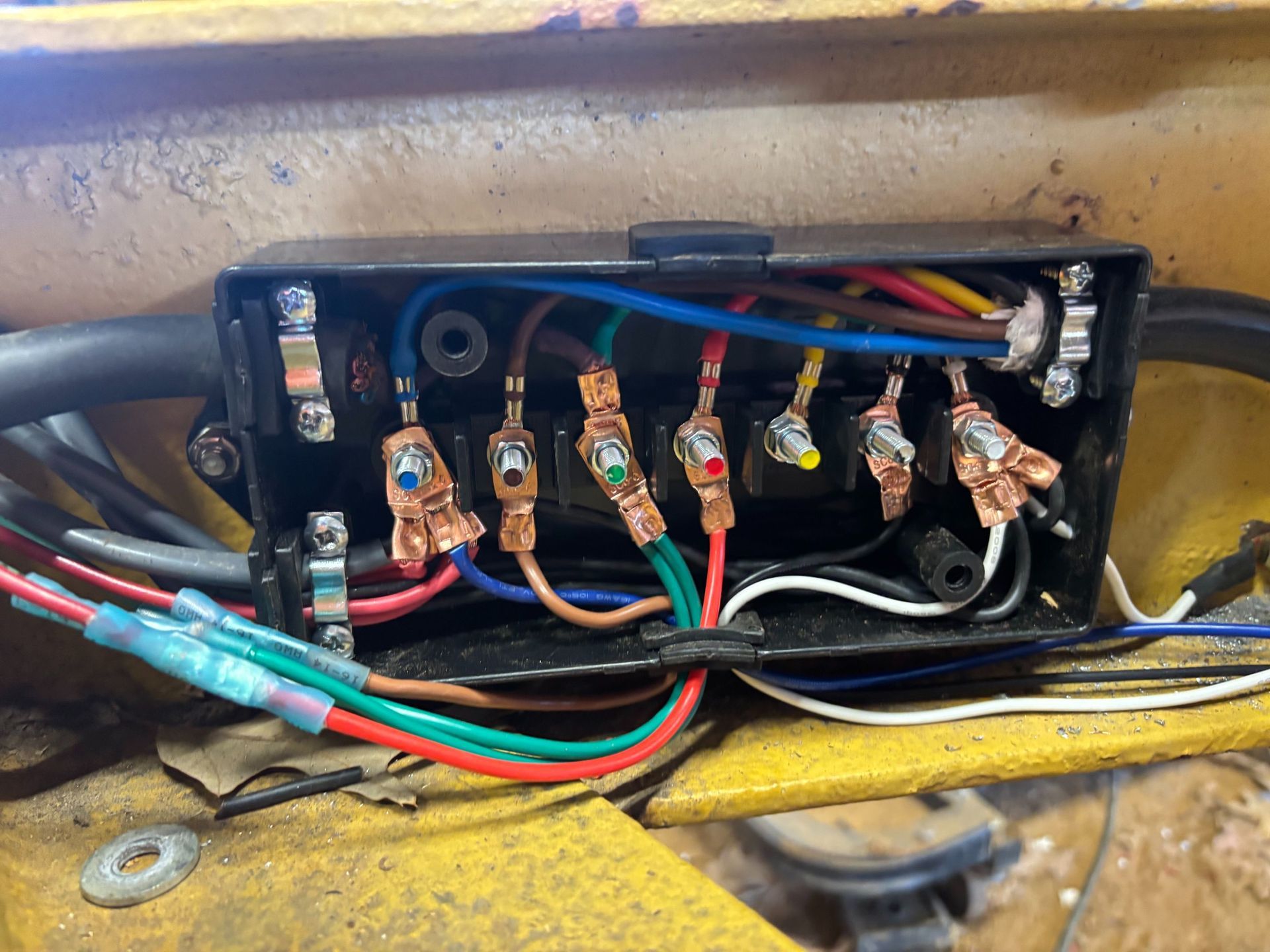 Trailer with a winch and battery setup, featuring black and red wires.