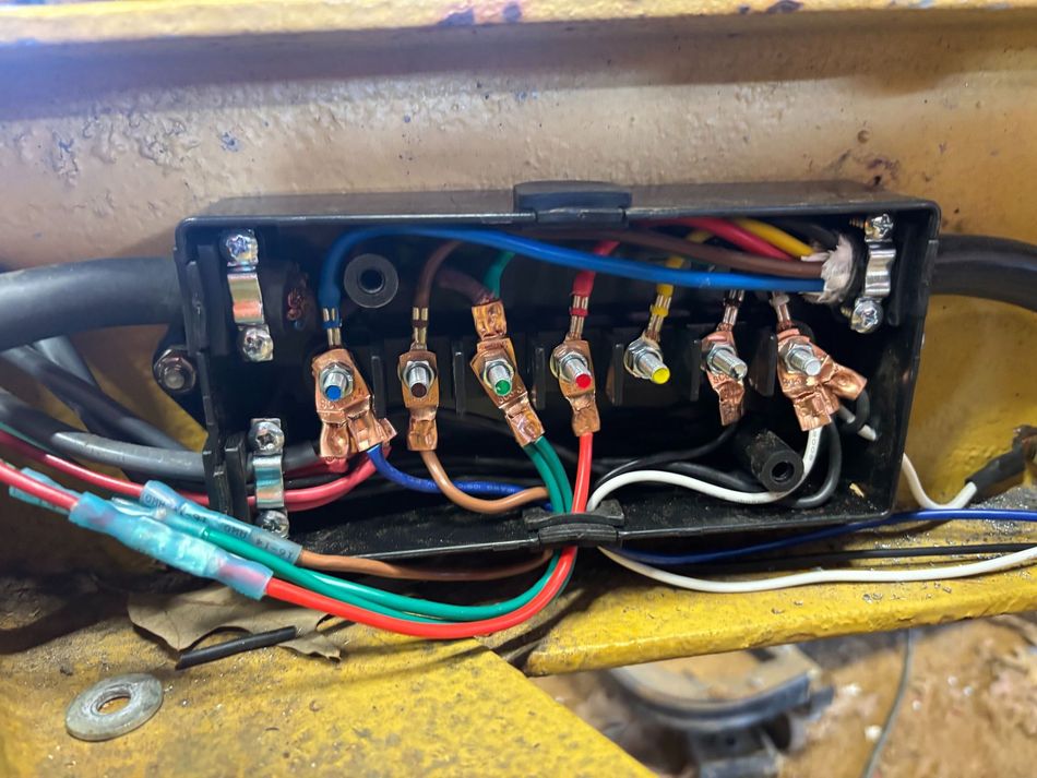 Trailer with a winch and battery setup, featuring black and red wires.