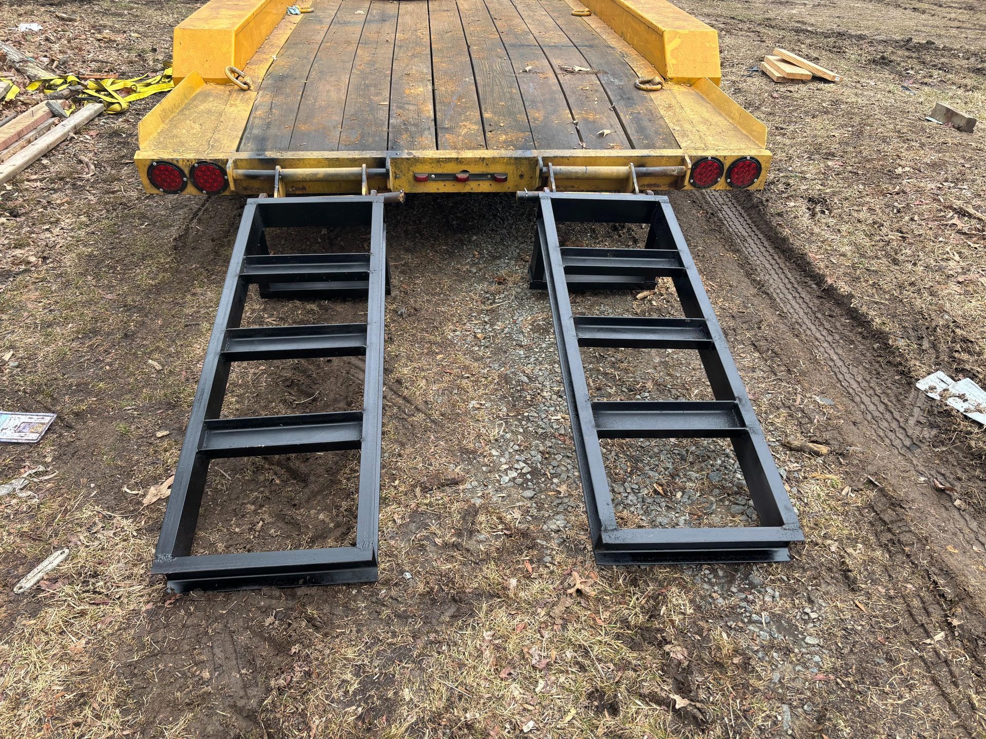A red ramp is sitting in a parking lot next to a building.
