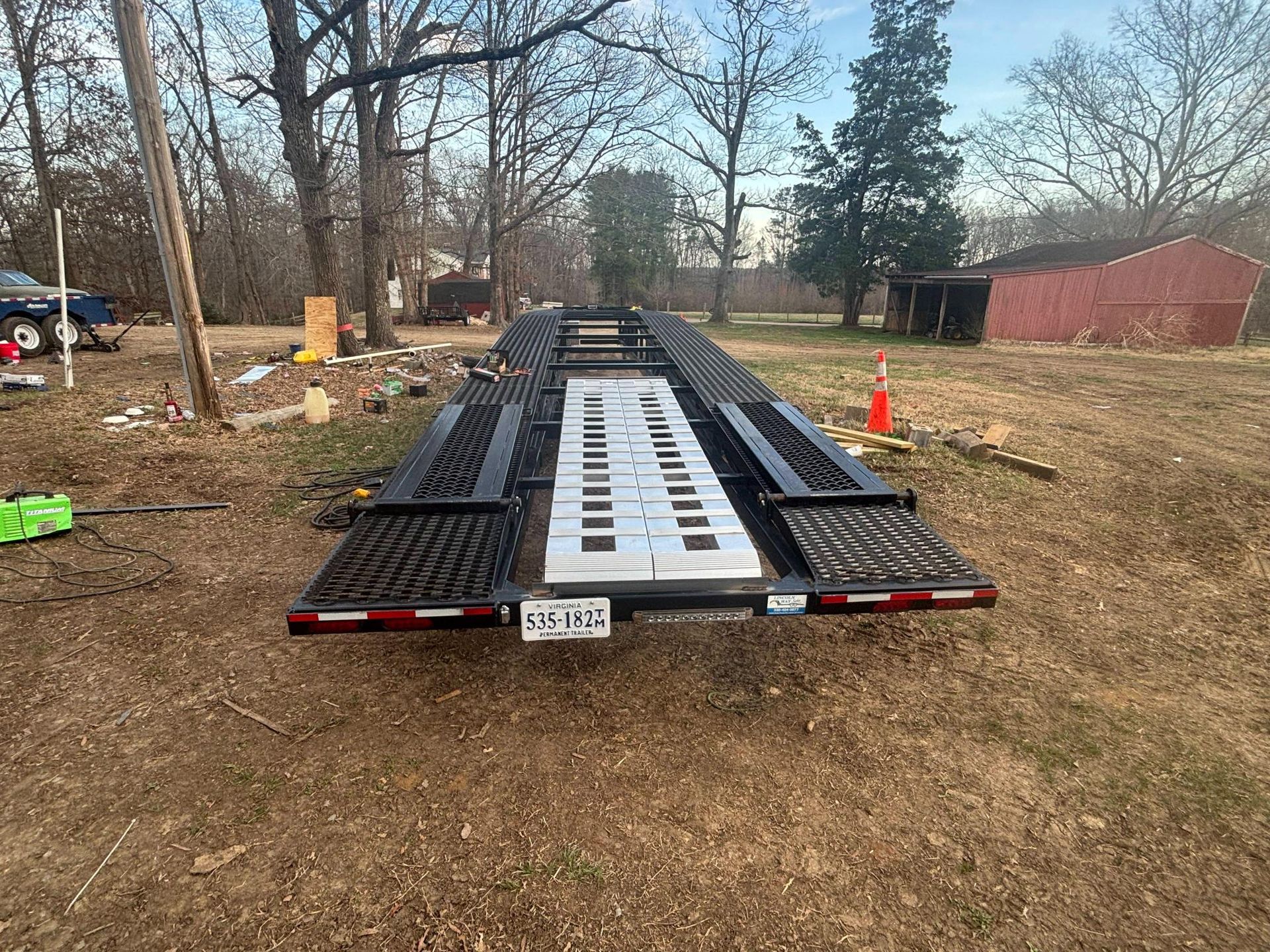 A man is working on a truck tire with a wrench.