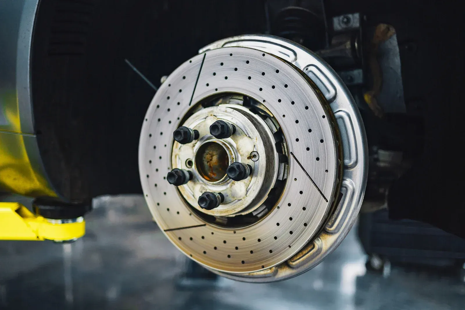 A close up of a brake disc on a car.