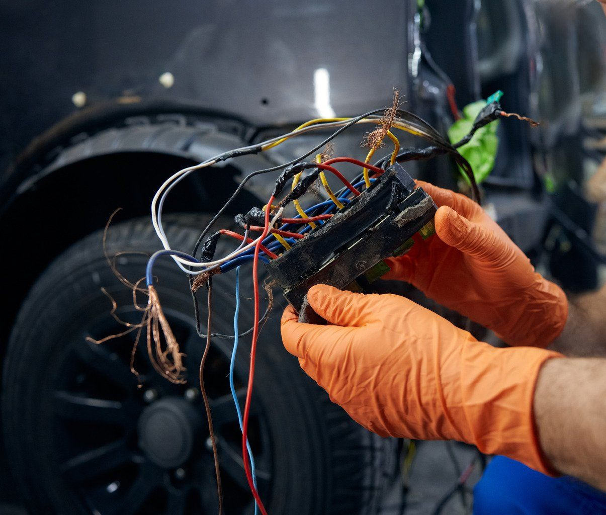 A car battery is being charged with jumper cables.