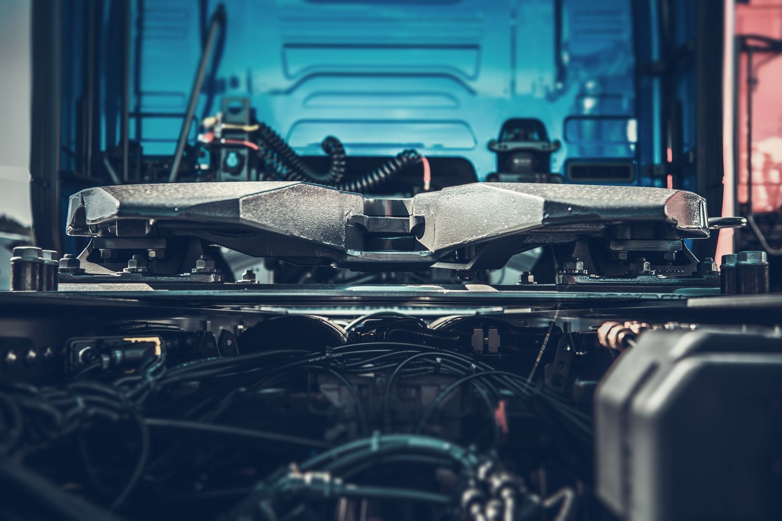 A close up of a truck engine with a trailer attached to it.
