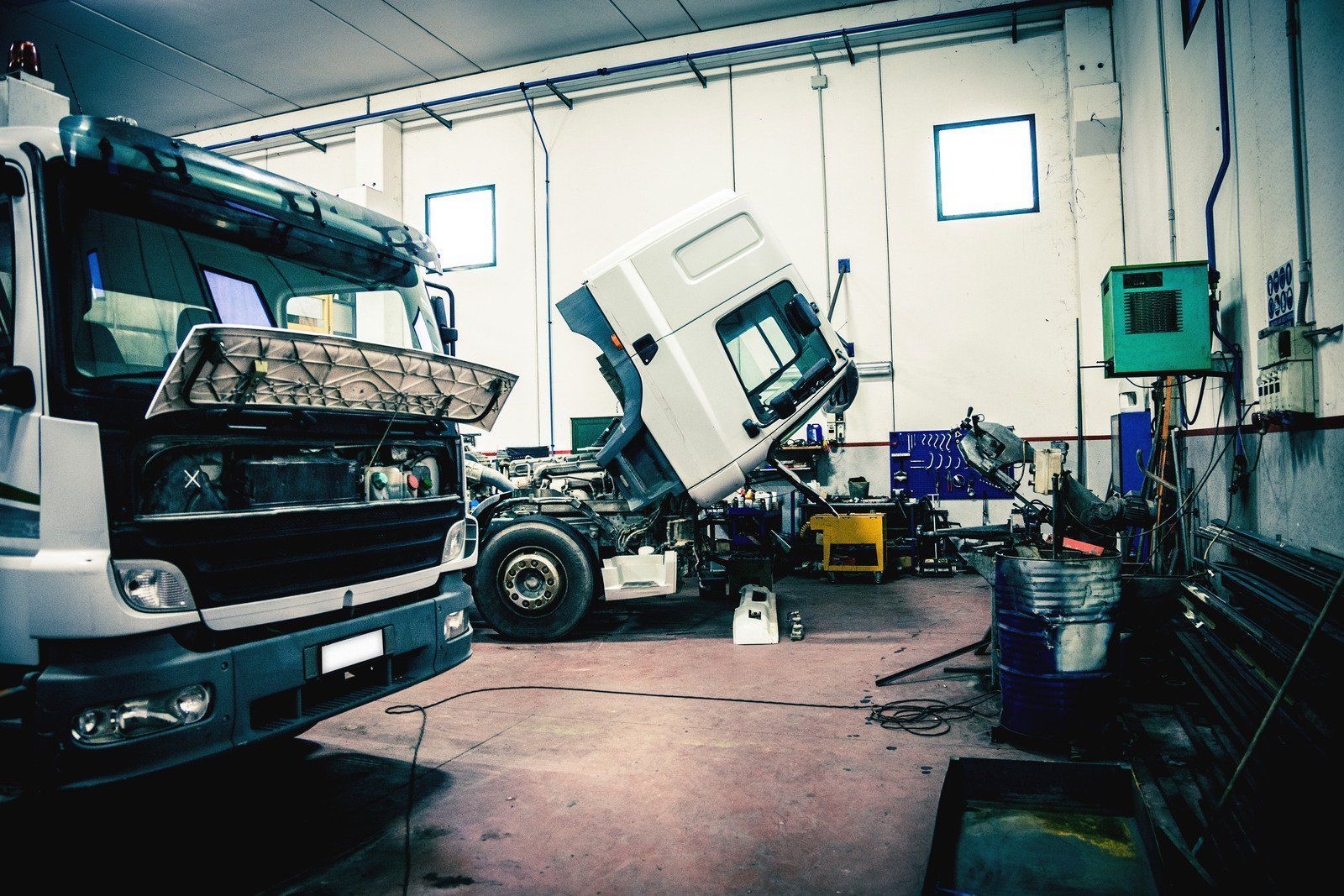 The inside of a semi truck with a white wall and orange stripes on the ceiling.