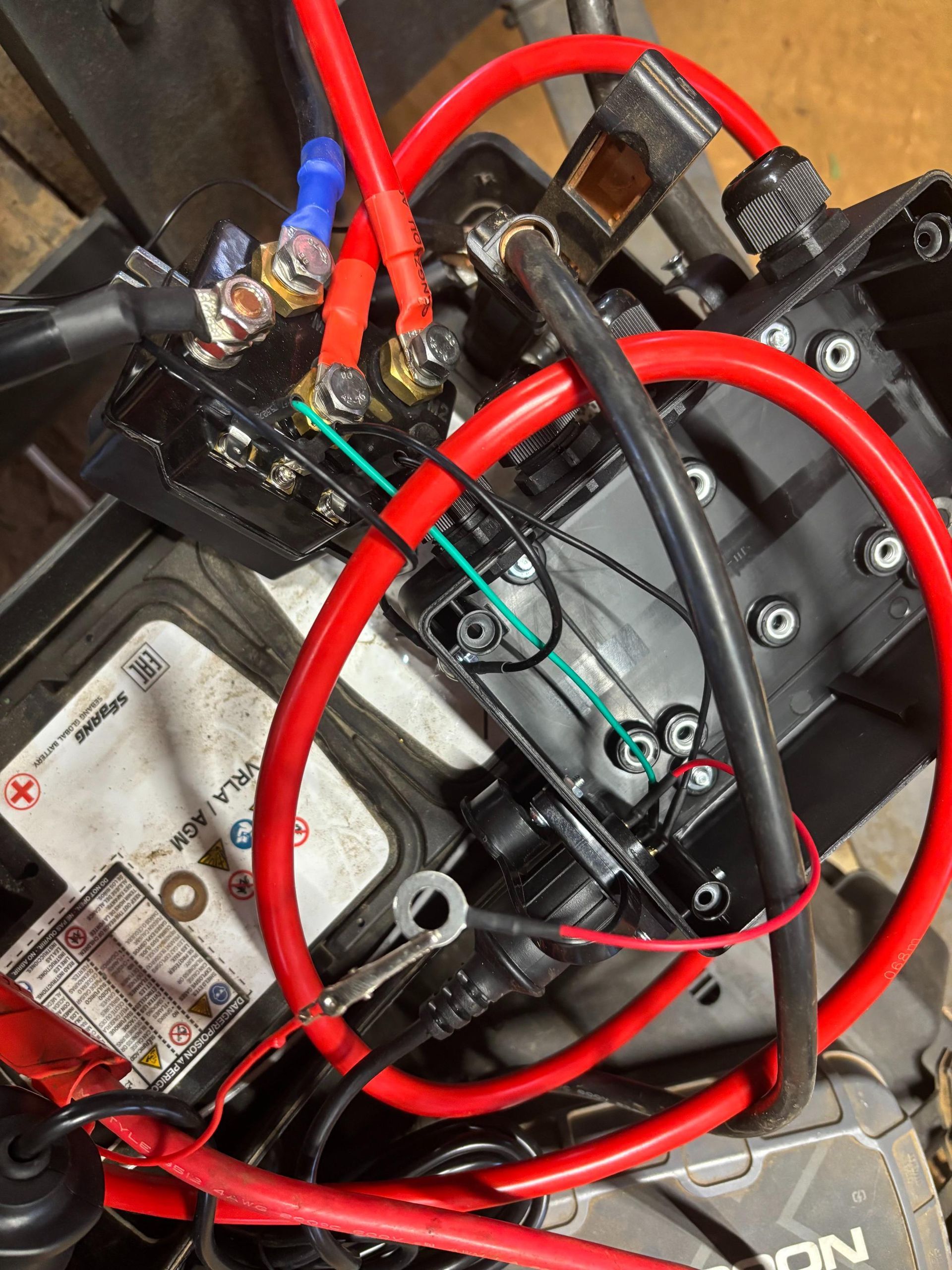 A man is working on the engine of a truck.