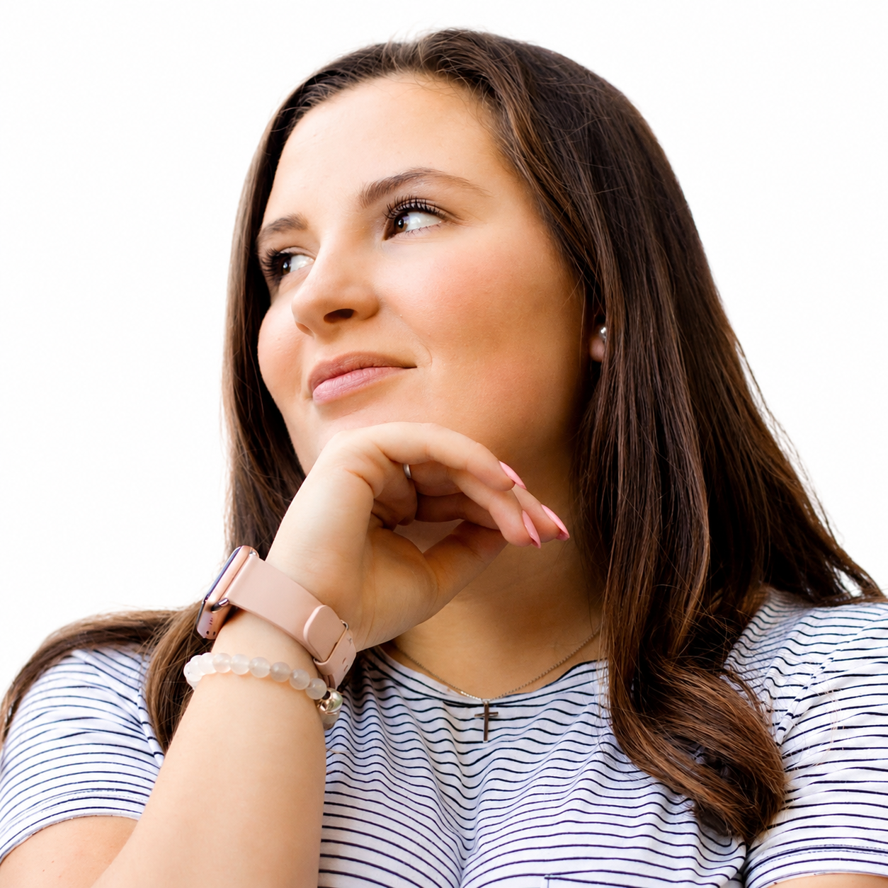 A woman in a striped shirt is smiling for the camera.