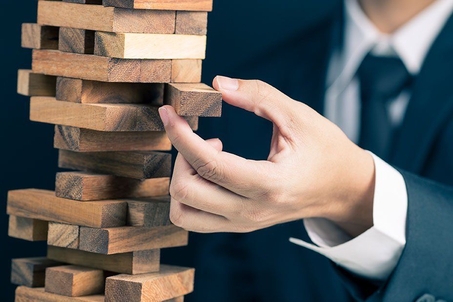 Business man playing jenga