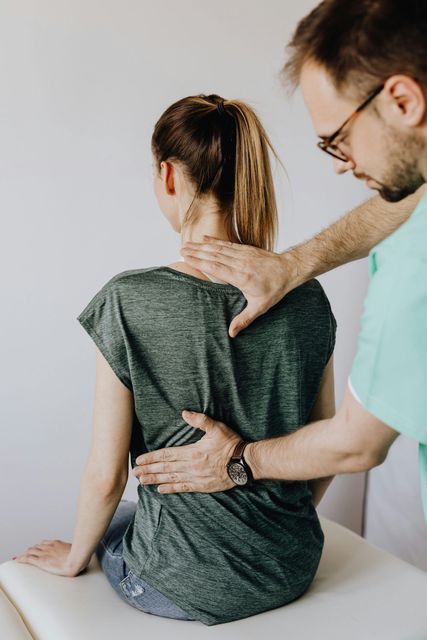 A man is giving a woman a massage on her back.