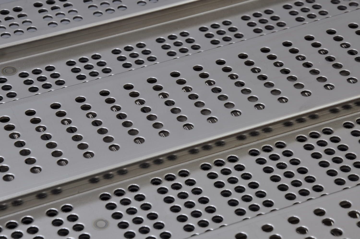 A Close up Of a Metal Grate with Holes in It — Betts Welding Pty Ltd In Moss Vale, NSW