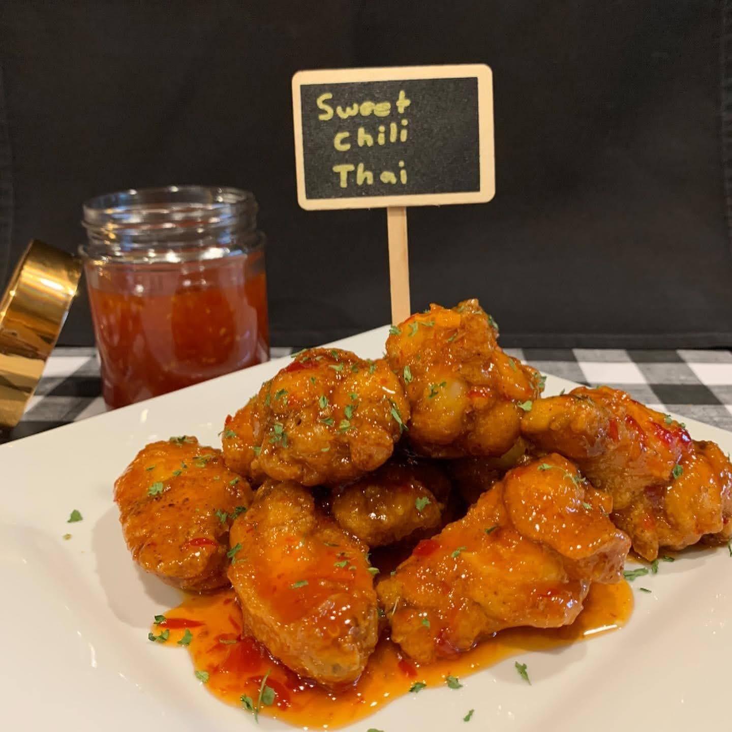 A plate of food with a sign that says sweet chili thai