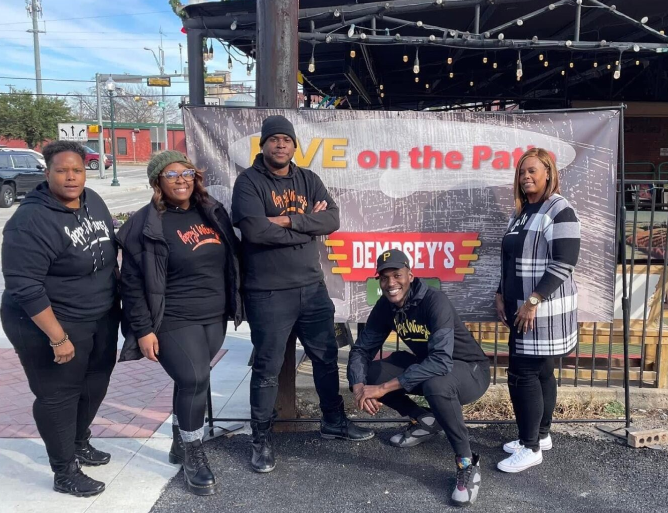 A group of people standing in front of a sign that says we on the park
