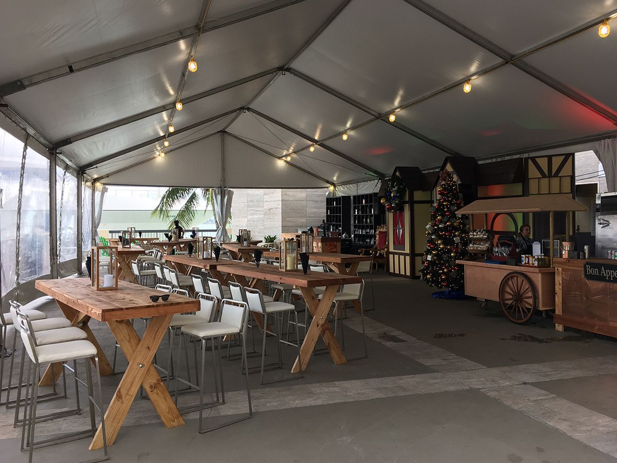 A large tent with tables and chairs inside of it.