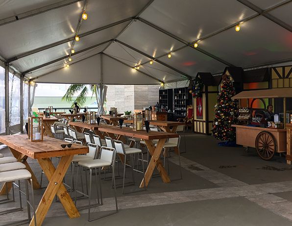 A large tent with tables and chairs inside of it