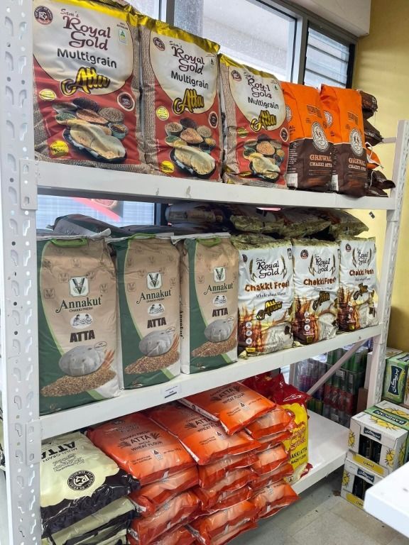A Shelf Filled With Bags Of Rice In A Store — Suhana Butcher & Grocery Shop In Millner, NT