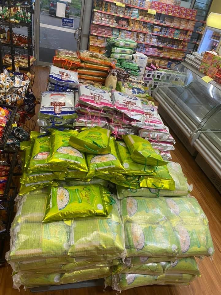 A Bunch Of Bags Of Rice Are Stacked On Top Of Each Other In A Grocery Store — Suhana Butcher & Grocery Shop In Millner, NT