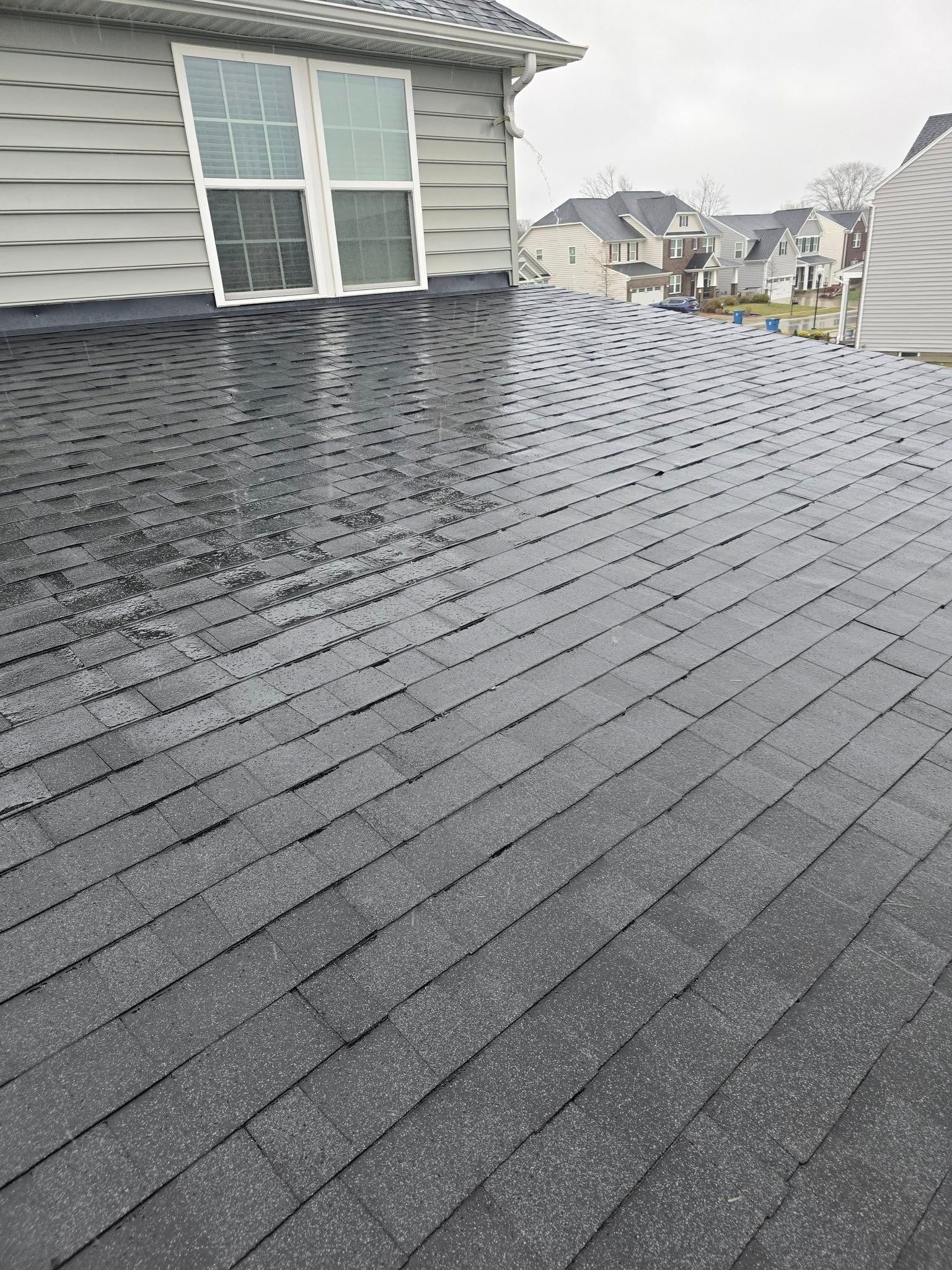 A brick house with a roof and a window