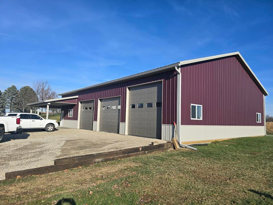 A white garage door is sitting in front of a brick house.