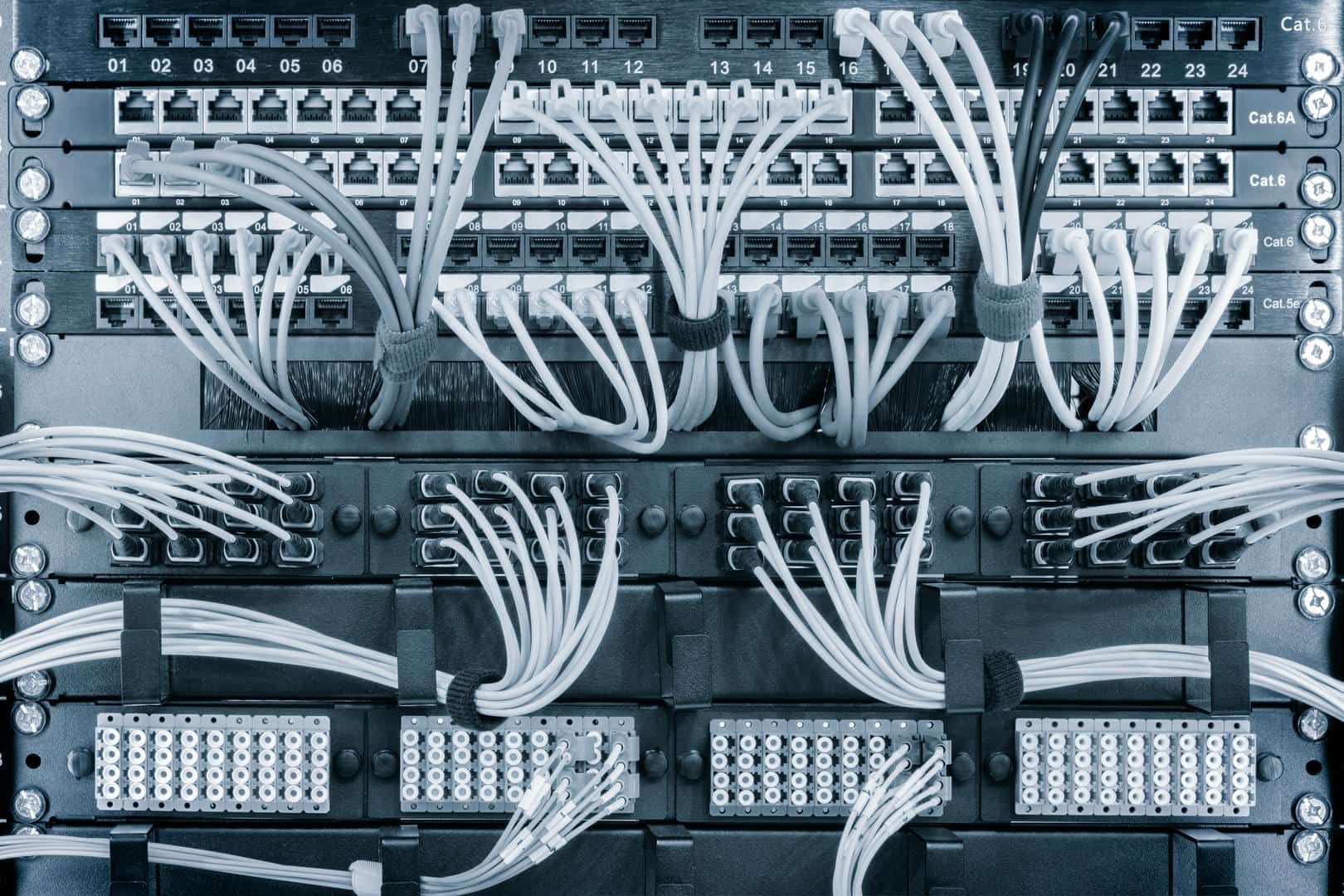 A server rack with a lot of wires coming out of it