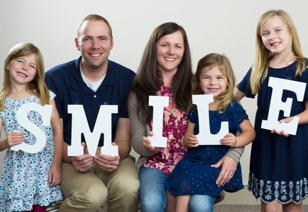 family holding smile letters