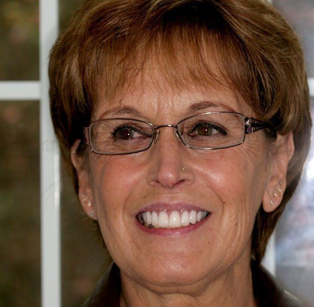 elder woman with glasses smiling