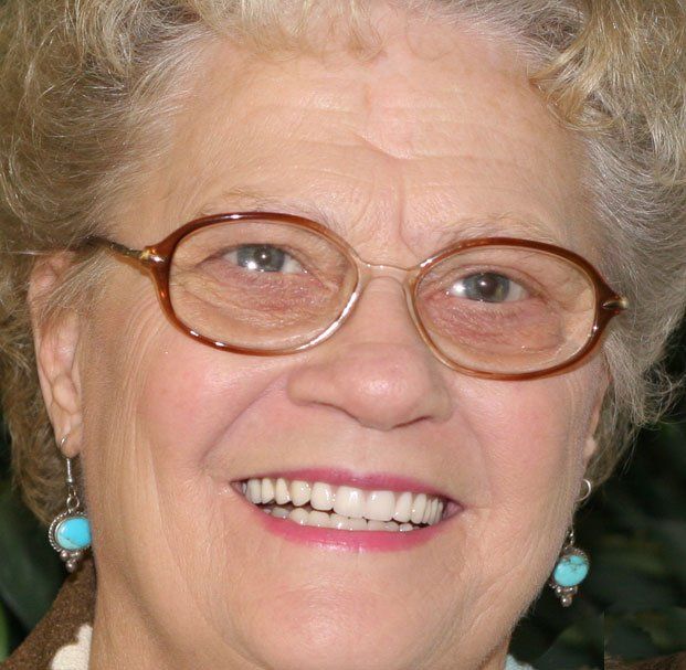 elder woman with glasses smiling