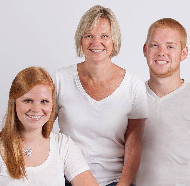 mother with two older kids smiling