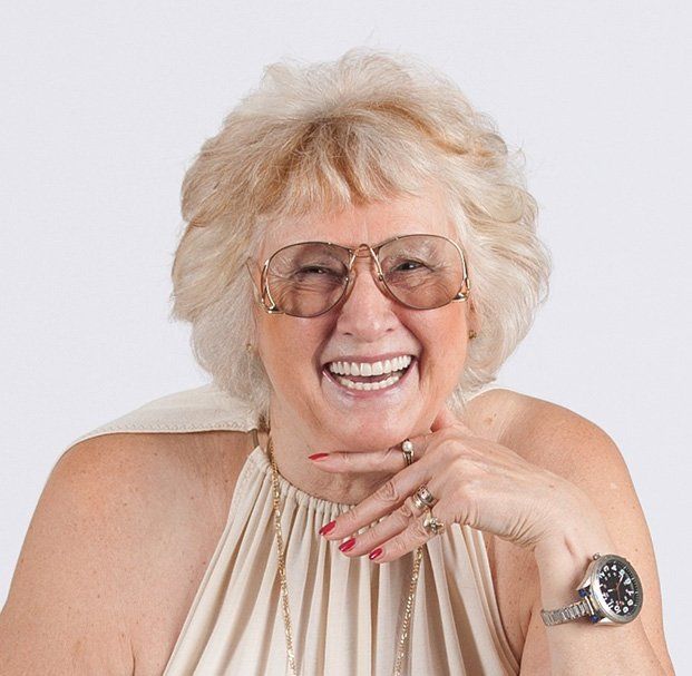 elder woman with glasses smiling