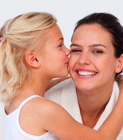 Daughter kissing mom's cheek