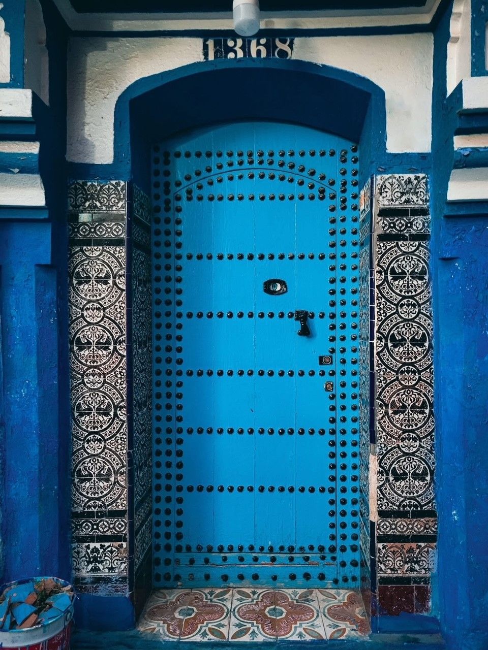 A blue door on a blue and white building