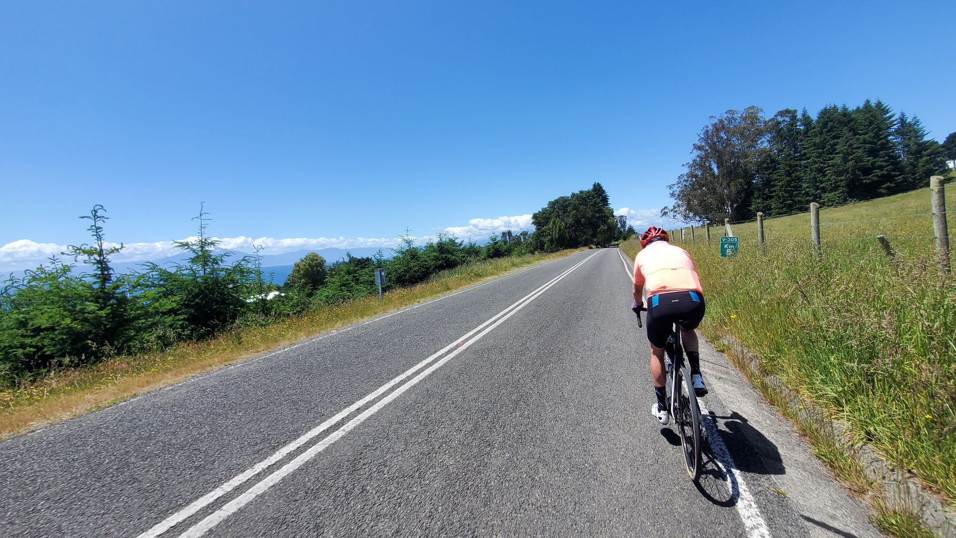 A person is riding a bike down a road.