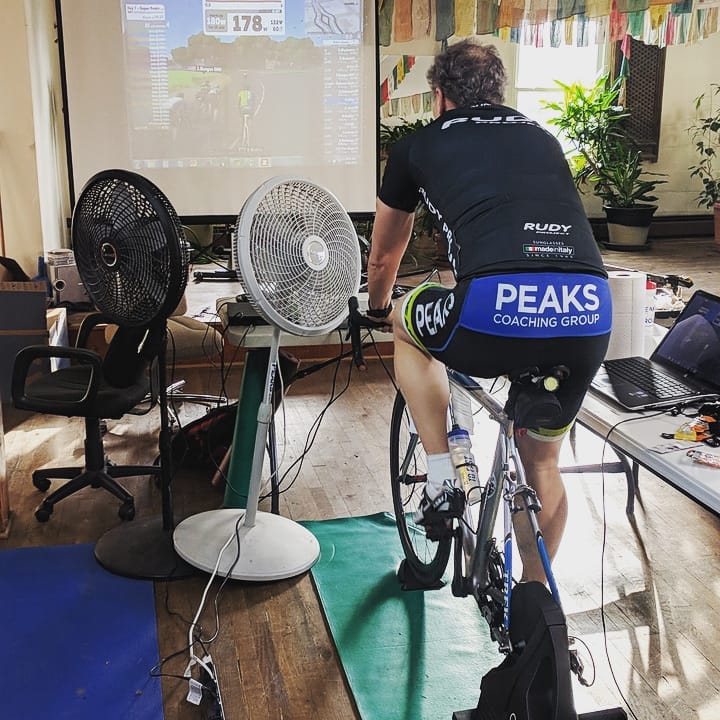 A man is riding a bike with the word peaks on the back