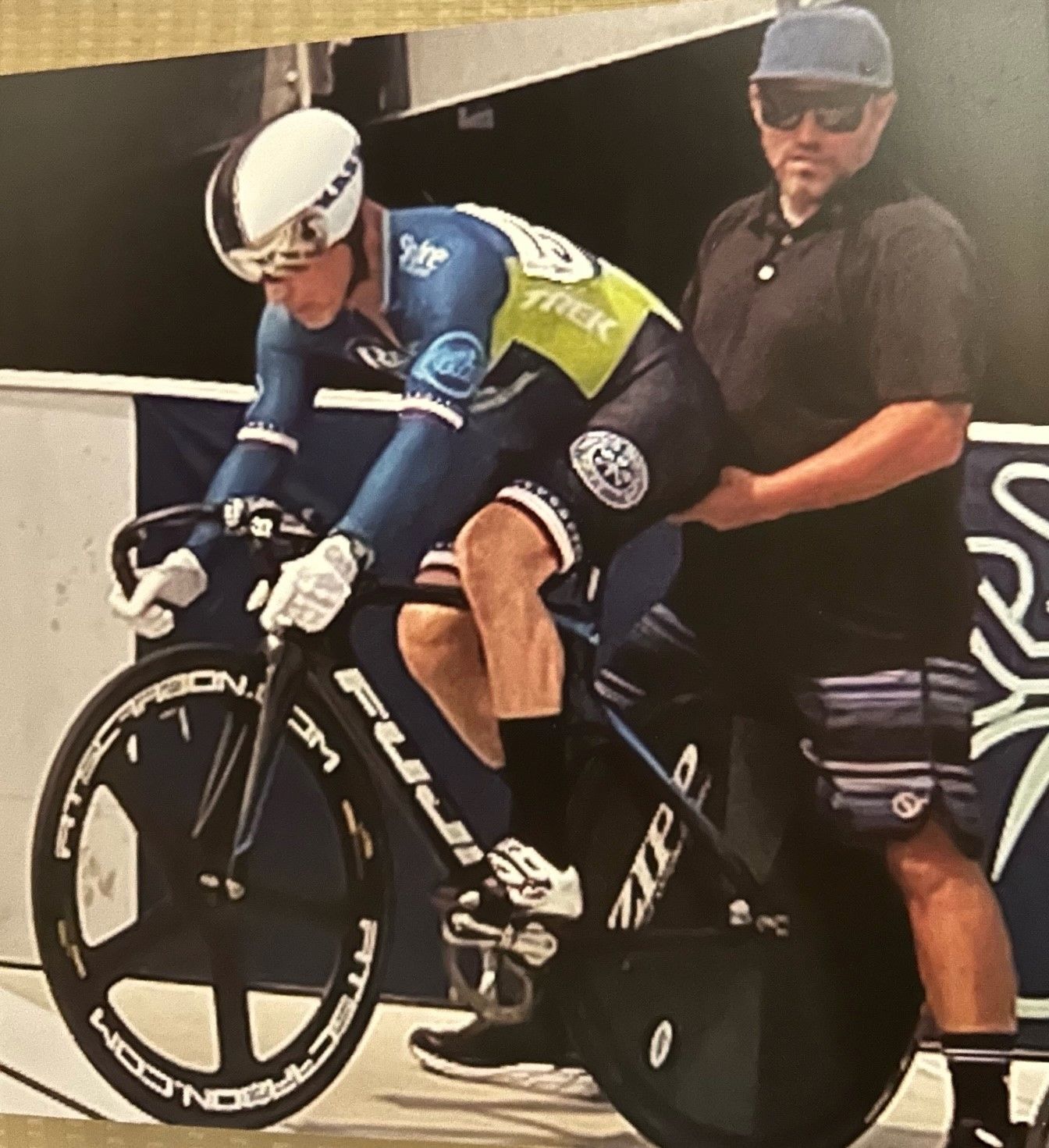 A man riding a bike with the word trek on his jersey