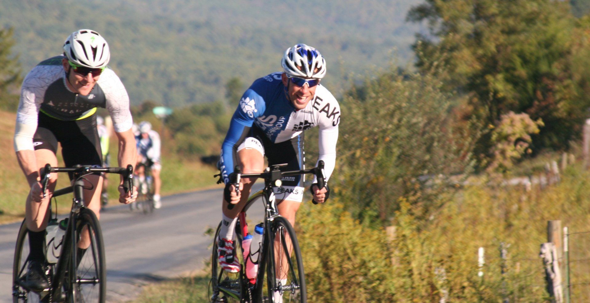 A group of people are riding bicycles down a road.