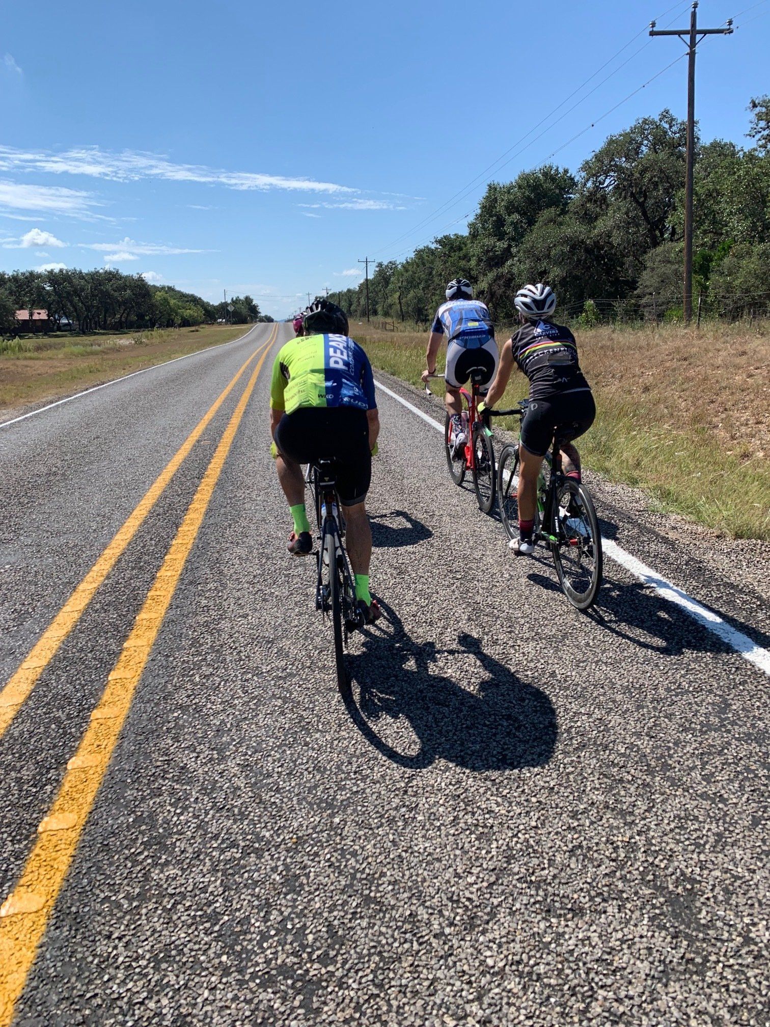 A group of people are riding bicycles down a road.