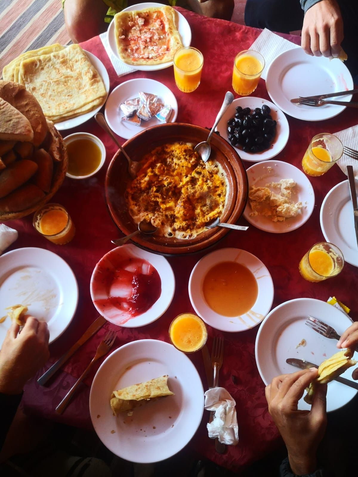 A table topped with plates of food and drinks