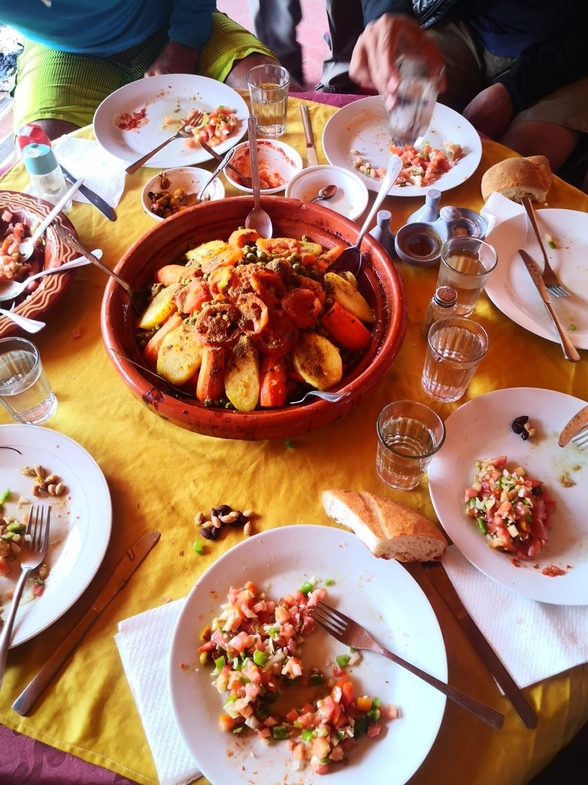 A table with plates of food and a bowl of food on it