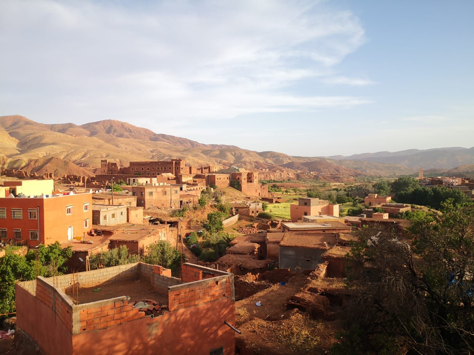 An aerial view of a village with mountains in the background