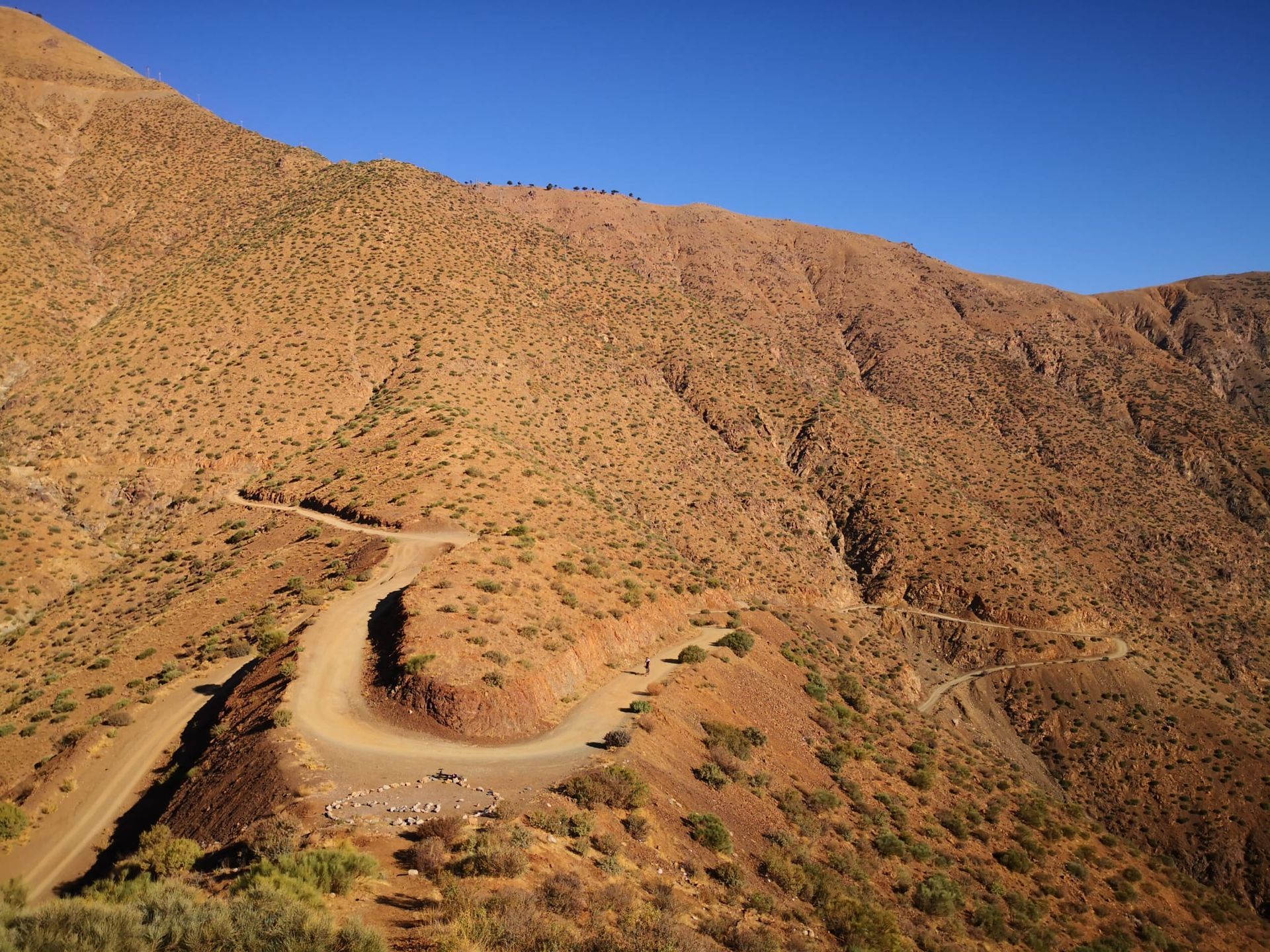 A dirt road winds through a desert landscape