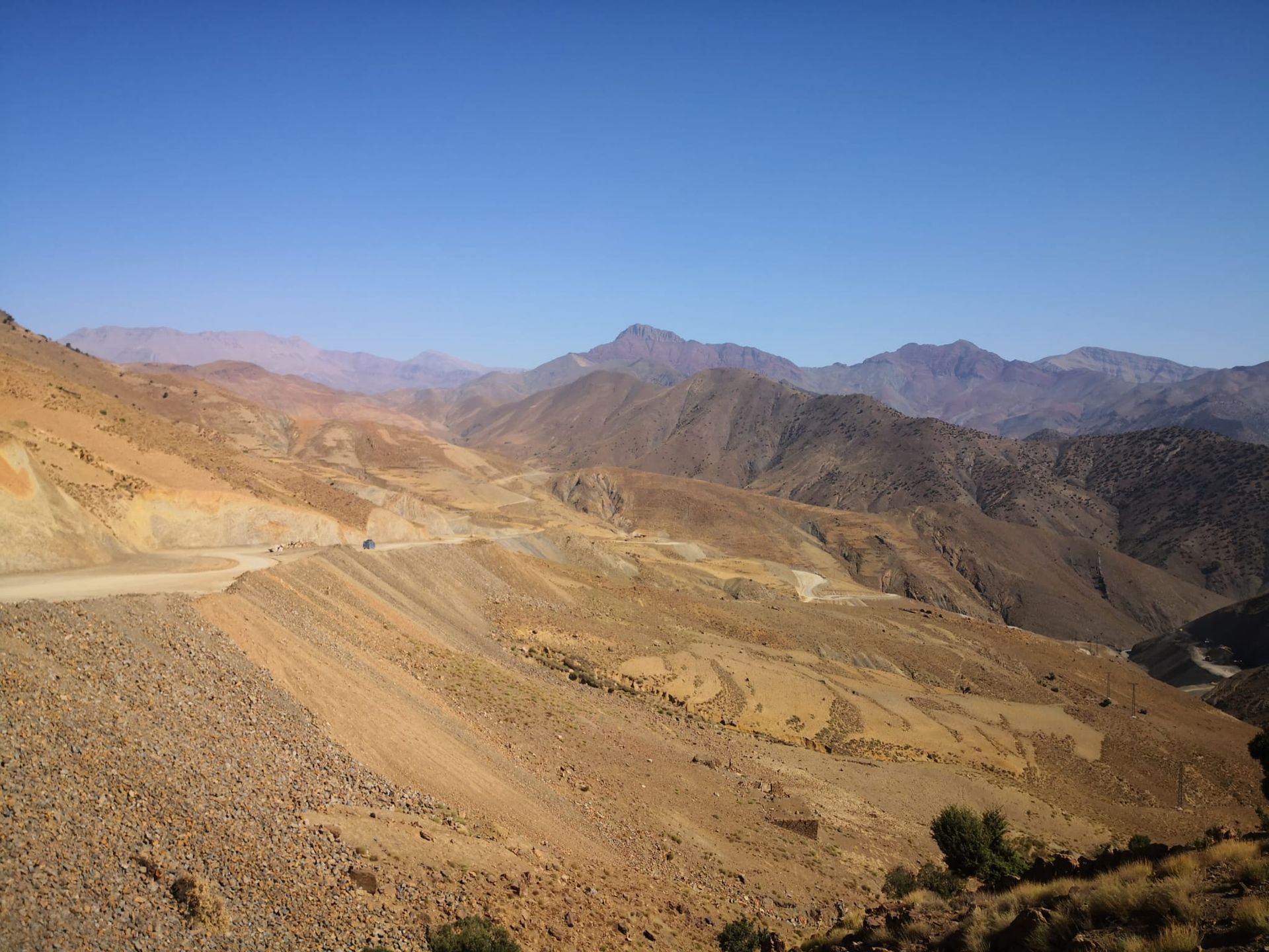 A desert landscape with mountains in the background and a road in the foreground