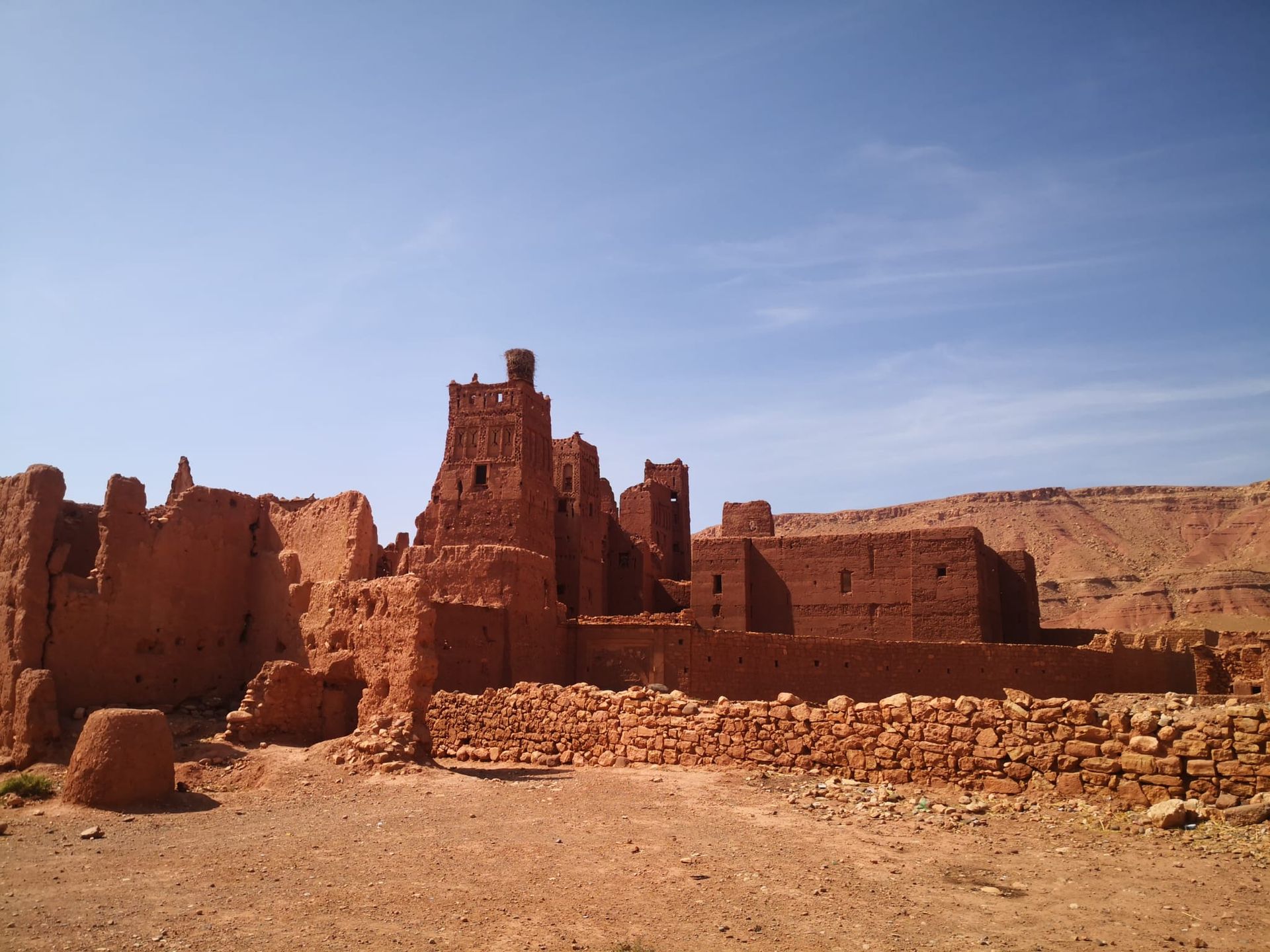 A castle in the desert with a blue sky in the background
