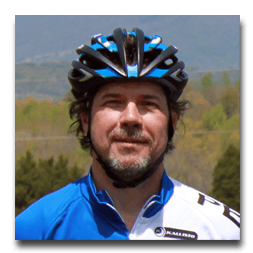 A man wearing a blue and black bicycle helmet