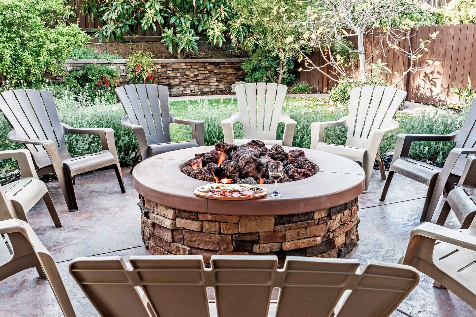 Fire Pit Surrounded by Wooden Rocking Chairs — Virginia Beach, VA — Premiere Construction Inc.