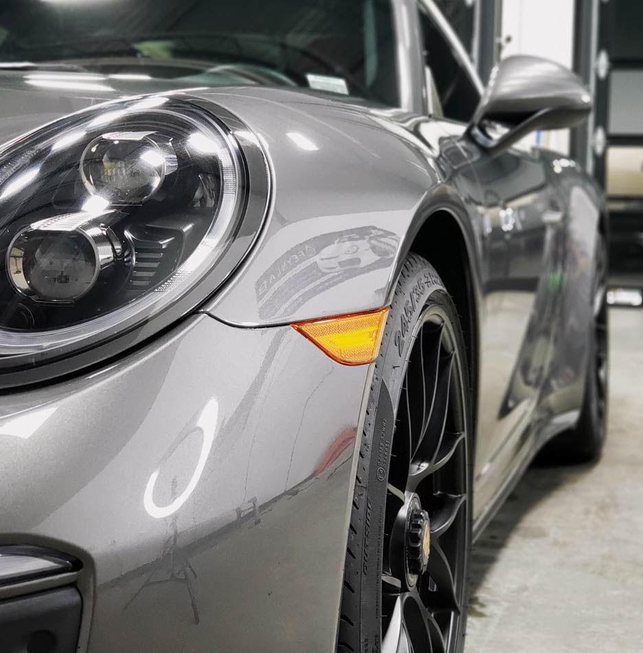 A close up of a car with the letter c on the side