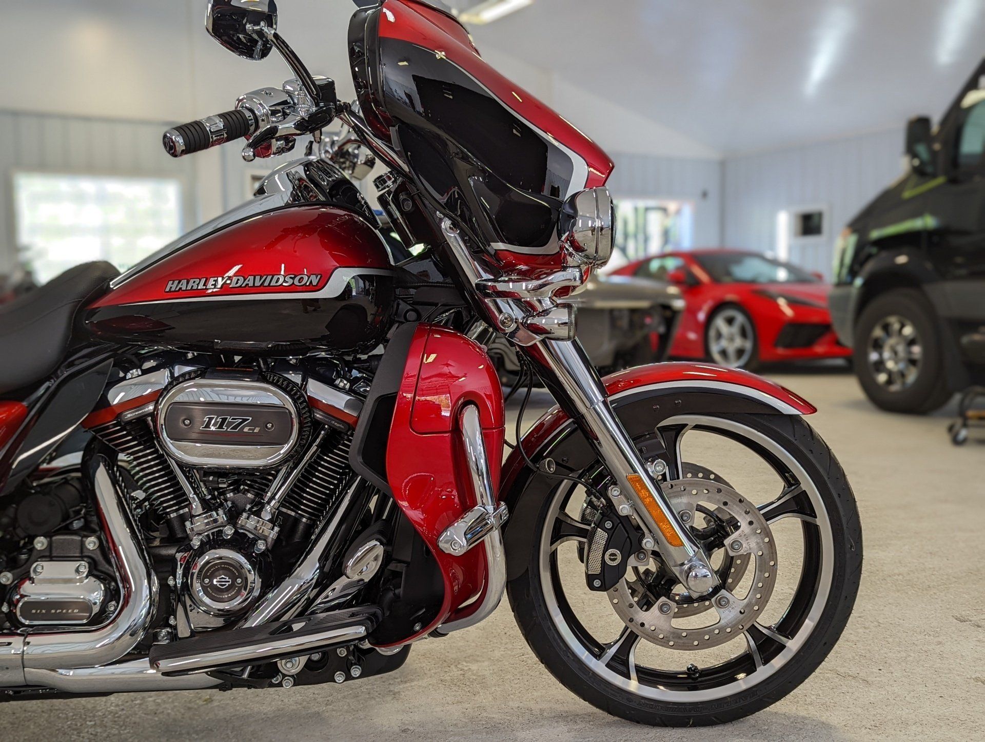 A red harley davidson motorcycle is parked in a garage
